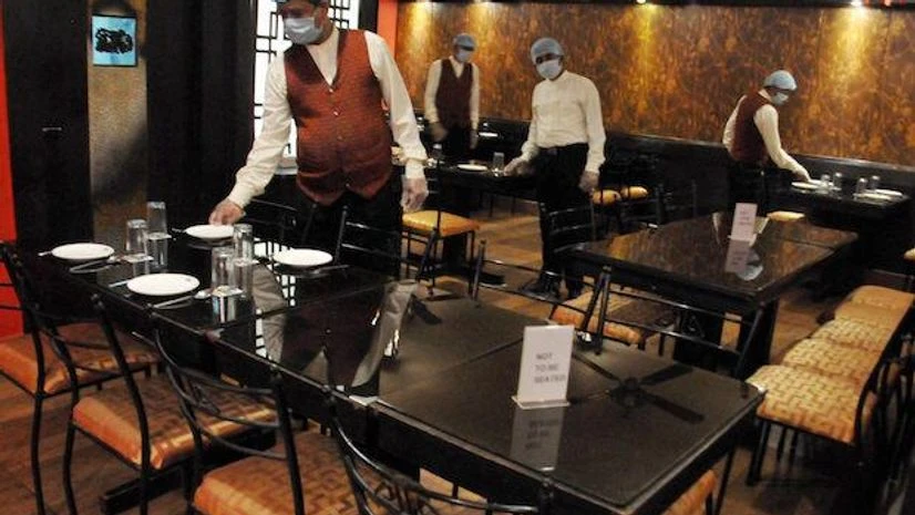 Kolkata, Restaurants, Covid-19 Staff members arrange plates on tables at Krystal Chopstick restaurant after authorities permitted to re-open eateries, during the fifth phase of COVID-19 nationwide lockdown, in Kolkata, Wednesday, June 10, 2020. (PTI)