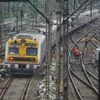 A suburban local train, running only for people associated with essential services, approches a station during ongoing COVID-19 lockdown, in Thane