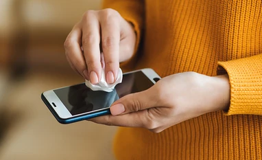 Disinfecting mobile phone, cleaning smart phone Representative image
