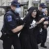 Tulsa Police officers arrest protester for trespassing after she entered the safety barricade of President Donald Trumps campaign rally Saturday June 20, 2020. AP/PTI