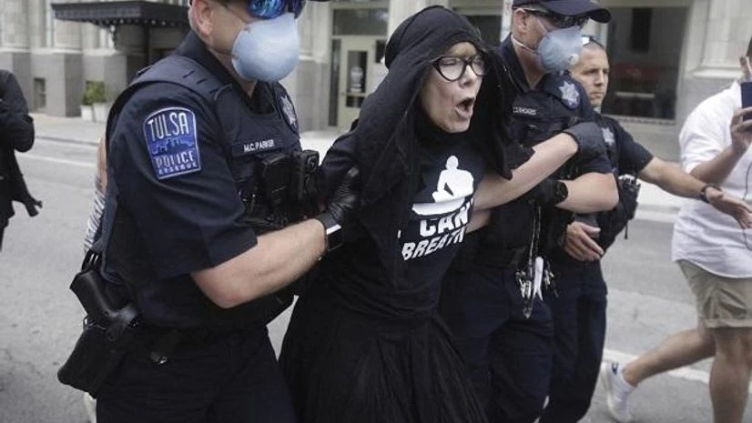 Trump's Tulsa rally Tulsa Police officers arrest protester for trespassing after she entered the safety barricade of President Donald Trumps campaign rally Saturday June 20, 2020. AP/PTI