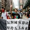 (L-R) Pan-democratic legislator Eddie Chu Hoi-dick, Vice convener for Hong Kong's Civil Human Rights Front Figo Chan, and activist Leung Kwok-hung, also known as "Long Hair", march at the anniversary of Hong Kong's handover to China from Britain.