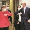 Germany’s Chancellor Angela Merkel and European Council President Charles Michel are seen bumping elbows ahead of the first face-to-face EU summit since the Covid-19 outbreak, in Brussels, on Friday. Finnish PM Sanna Marin and French President Emmanu