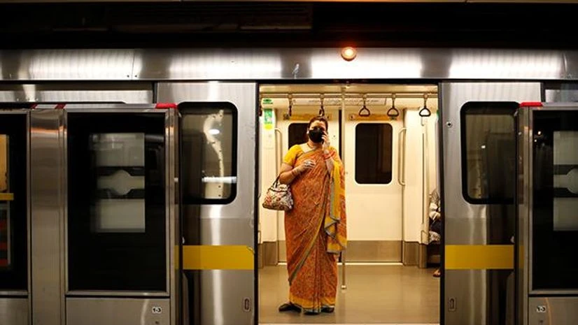 Metro station, metro services, Delhi Metro A passenger wearing face mask takes a train at a Delhi metro train station, on the first day of the restart of their operations, amidst the spread of coronavirus disease (COVID-19), in New Delhi. Photo: Reuters