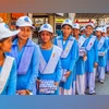 School students School girls standing in line in uniforms and with lunch packs on a school trip. Photo: Shutterstock