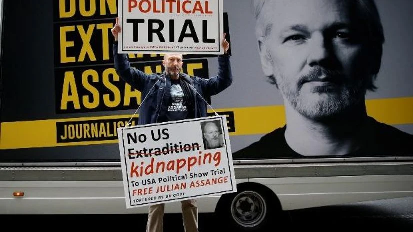 Julian Assange A protestor holds signs outside the Old Bailey, the Central Criminal Court ahead of a hearing to decide whether Assange should be extradited to the United States, in London