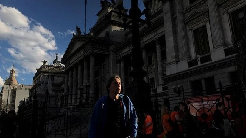 Argentina A man walks past the Congress in Buenos Aires, Argentina. Photo: Reuters