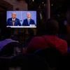 A television screen broadcasts the final 2020 presidential campaign debate between Joe Biden and US President Donald Trump. Photo: Reuters