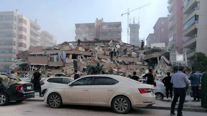 Earthquake, Turkey People work on a collapsed building, in Izmir, Turkey, Friday, Oct. 30, 2020, after a strong earthquake in the Aegean Sea has shaken Turkey and Greece