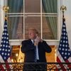 After returning from Walter Reed, President Donald Trump ascended to the Blue Room balcony where he removed his mask and acknowledged supporters and White House staff. Photo: Bloomberg