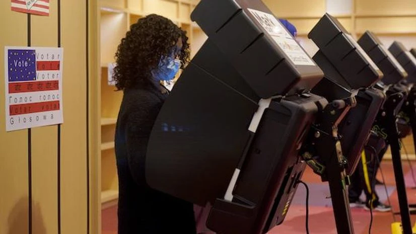 US Elections A woman casts her ballot on the first day of early voting in a recently-shuttered store at Oak Park Mall Saturday, Oct. 17, 2020, in Overland Park, Kan. (AP Photo/Charlie Riedel, File)