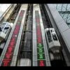 Stock tickers are displayed on a wall