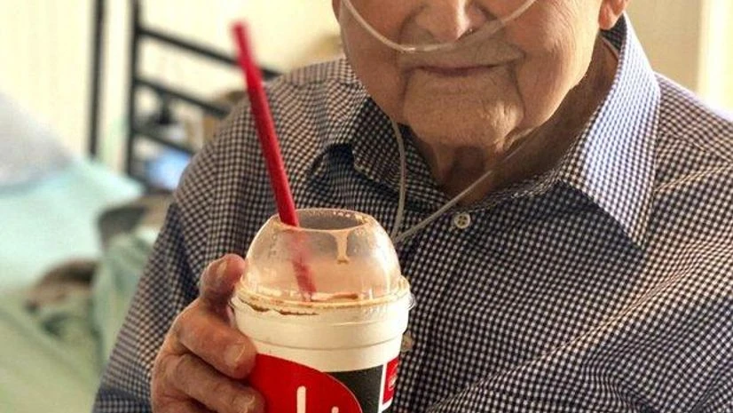 world war 2 veteran In this photo provided by Holly Wooten McDonald, World War II veteran and COVID-19 survivor Major Wooten holds a celebratory milkshake on his 104th birthday on Thursday, Dec. 3, 2020, in Madison, Alabama. Wooten was released from the hospital this we