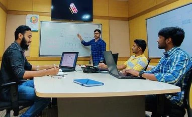 Anirudh Sharma and Tanveer Ahmed Two of the co-founders of Digantara, Anirudh Sharma (extreme right, on chair, in light blue check shirt) and Tanveer Ahmed (extreme left, on chair) at the startup's office