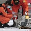 Rescuers inspect debris found in the waters around the location where a Sriwijaya Air passenger jet has lost contact with air traffic controllers shortly after the takeoff