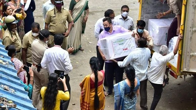 Serum Institute vaccine, Covishield Workers unload the first consignment of COVID-19 vaccine, dispatched from Punes Serum Institute of India, from a temperature-controlled truck to a storage facility in Bengaluru, Tuesday, Jan. 12, 2021. (PTI Photo/Shailendra Bhojak)