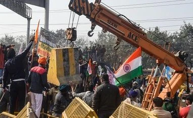 I feel ashamed and take responsibility: Yogendra Yadav on Delhi violence Farmers remove a barricade during their tractor rally to protest against Centres farm reform laws, amid the 72nd Republic Day celebrations, at GT Karnal road in New Delhi, Tuesday, Jan. 26, 2021. (PTI Photo/Shahbaz Khan)