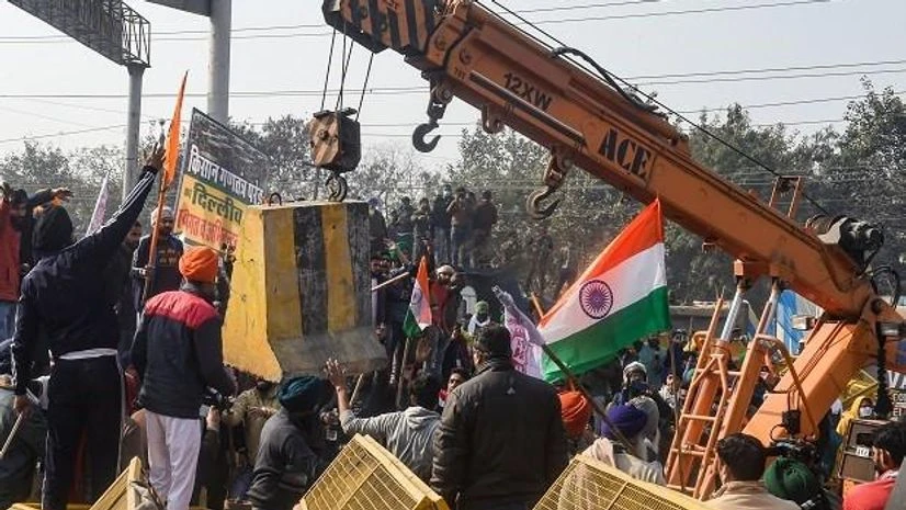 Farmers remove a barricade during their tractor rally to protest against Centres farm reform laws, amid the 72nd Republic Day celebrations, at GT Karnal road in New Delhi, Tuesday, Jan. 26, 2021. (PTI Photo/Shahbaz Khan) Farmers remove a barricade during their tractor rally to protest against Centres farm reform laws, amid the 72nd Republic Day celebrations, at GT Karnal road in New Delhi, Tuesday, Jan. 26, 2021. (PTI Photo/Shahbaz Khan)
