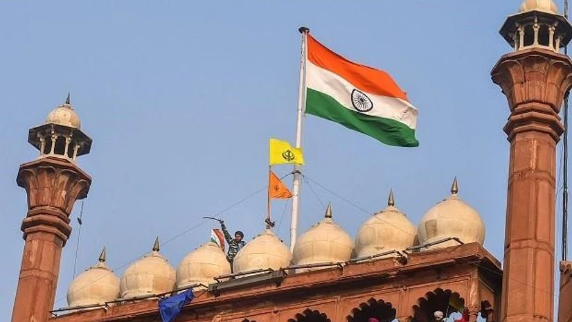 Red Fort, national flag, Indian flag Farmers hoist flags at the Red Fort during the tractor rally amid the 72nd Republic Day celebrations, in New Delhi, Tuesday, Jan. 26, 2021. (PTI Photo/Arun Sharma)