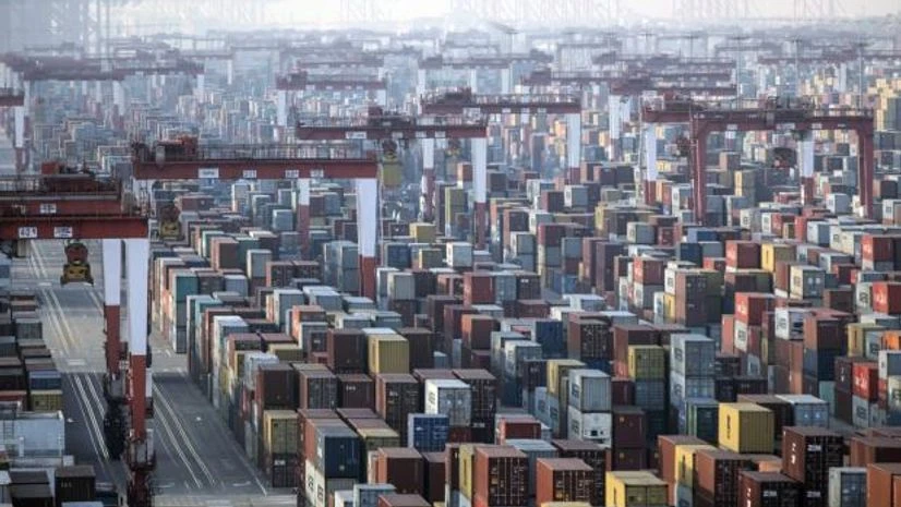 shipping containers Shipping containers next to gantry cranes at the Yangshan Deepwater Port in Shanghai, China, on Monday, Jan, 11, 2021. Photo: Bloomberg