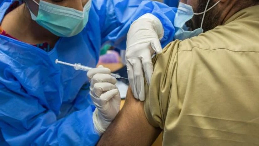 pakistan vaccination programme A health worker administers a dose of the Sinopharm Group Co. Covid-19 vaccine to a colleague in Karachi. Photo: Bloomberg