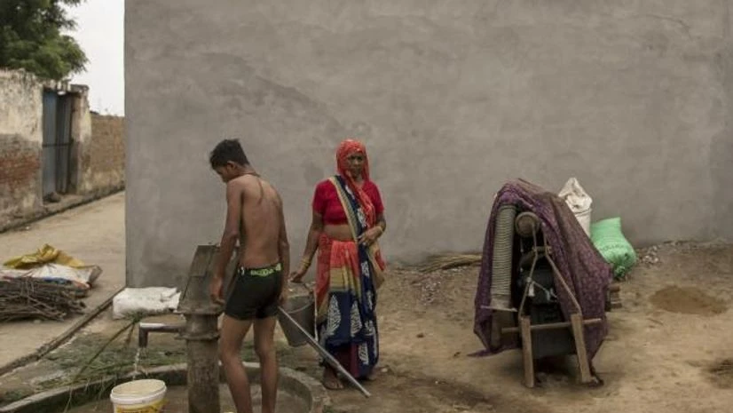 water pump People collect water from a pump at a village in Khair district, Uttar Pradesh, India, on Wednesday, Sept. 2, 2020