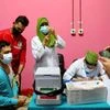 A man waits to get vaccinated with an injection of the Covishield at the Dhaka Medical College vaccination centre in Dhaka (Photo: Reuters)