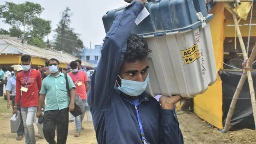 voting Polling officials carrying EVMs and other materials to a polling centre, ahead of 5th phase of West Bengal Assembly Polls, amid surge in Covid-19 cases across the country, in Nadia (Photo: PTI)
