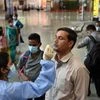A health worker takes swab samples from a passenger at Chhatrapati Shivaji Maharaj Terminus Railway Station, amid spike in Covid-19 cases, in Mumbai (Photo: PTI)