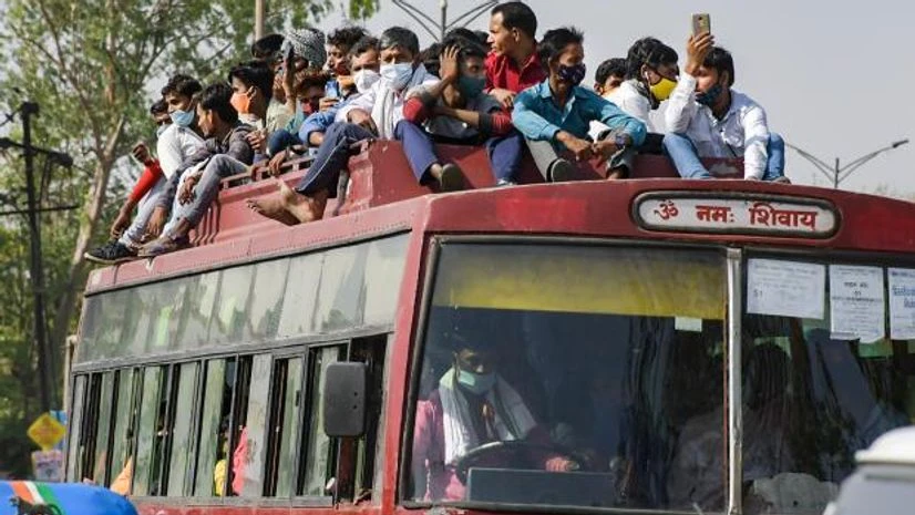 migrant workers Large numbers of migrants at Kaushambi bus stand to board buses for their native place , after lockdown announcement in National Capital in the wake of rising Covid-19 cases, in New Delhi (Photo: PTI)