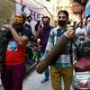 People carry empty oxygen cylinders for free refilling provided by Residence Welfare Association (RWA) of Turkman Gate, as COVID-19 case spike in New Delhi