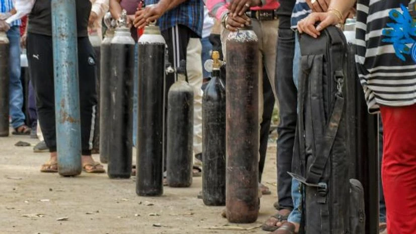 waiting for oxygen Family members of COVID-19 patients wait outside an oxygen-filling center to refill their empty cylinders, as demand for the gas rises due to spike in coronavirus cases, at Mayapuri in New Delhi (Photo: PTI)