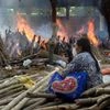 A family member during mass cremation of Covid-19 victims and others takes place at Gazipur Crematorium, in New Delhi, Monday, April 26, 2021. (PTI Photo/Manvender Vashist)