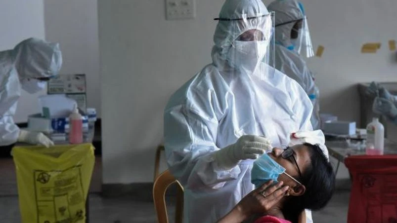 covid testing A medic, in PPE suit, collects nasal swab for Covid-19 test, amid the rise in Covid-19 cases across the country, Kochi (Photo: PTI)