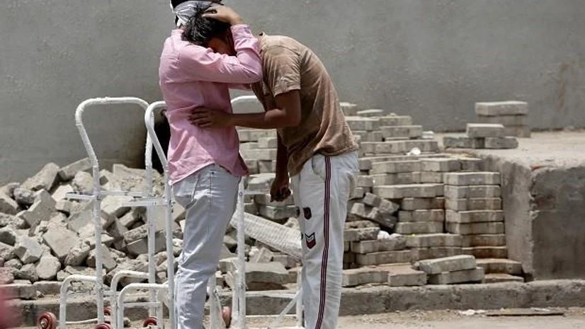 covid19, coronavirus, ahmedabad Relatives of a patient grieve outside a Covid-19 hospital in Ahmedabad, Tuesday, April 27, 2021.