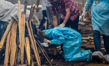 Coronavirus: Puducherry records highest single day number of deaths File photo: A person reacts at the cremation of a Covid-19 victim