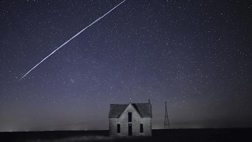 satellite, SpaceX StarLink satellites In this photo taken May 6, 2021, with a long exposure, a string of SpaceX StarLink satellites passes over an old stone house near Florence, Kan. The train of lights was actually a series of relatively low-flying satellites launched by Elon Musk's Spa