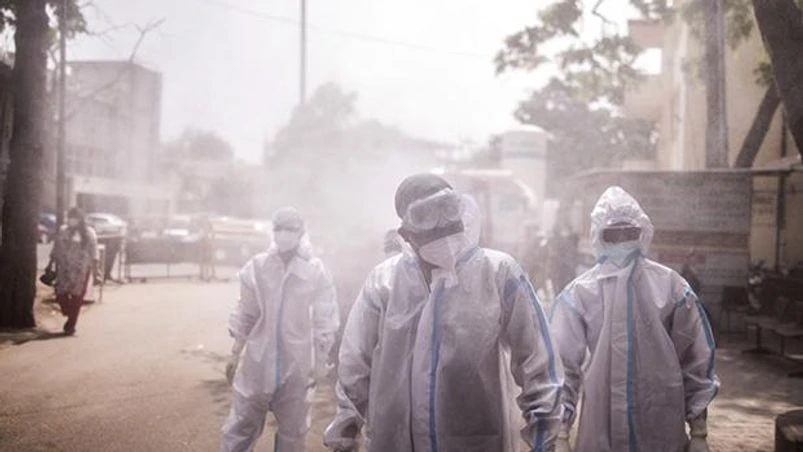 Coronavirus, Covid-19, PPE kit, frontline worker Frontline workers are sprayed with disinfectant at a Covid-19 Care Center set up at the Sarojini Naidu Medical College (SNMC) in Agra, Uttar Pradesh, India. Photo: Bloomberg
