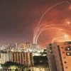 Streaks of light are seen as Israel's Iron Dome anti-missile system intercepts rockets launched from the Gaza Strip towards Israel, as seen from Ashkelon, Israel. 	Photo:?Reuters