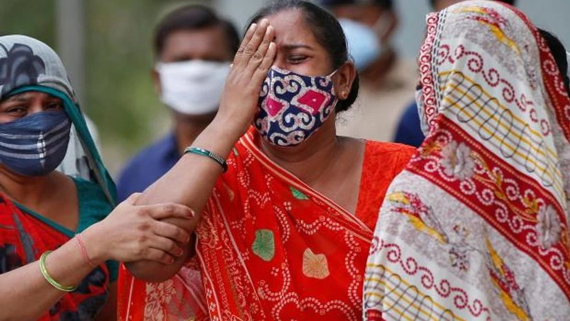covid deaths A woman mourns after her husband died due to the coronavirus disease outside a mortuary of a COVID-19 hospital in Ahmedabad (Photo: Reuters)