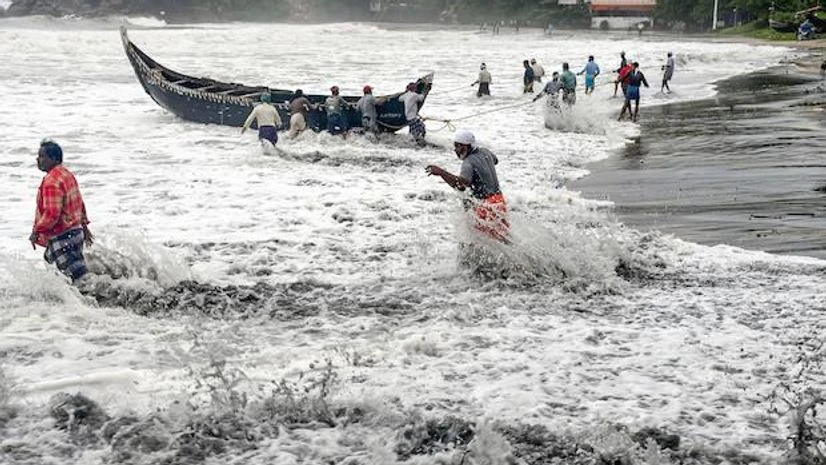 People pull a boat ashore, which sailed away amid strong winds, after a red alert in view of a cylonic formation in the Arabian Sea, in Thiruvananthapuram, Friday, May 14, 2021. People pull a boat ashore, which sailed away amid strong winds, after a red alert in view of a cylonic formation in the Arabian Sea, in Thiruvananthapuram, Friday, May 14, 2021.