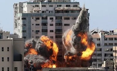 China urges US to play a constructive role to end conflict in Gaza A ball of fire erupts from a building housing various international media, including The Associated Press, after an Israeli airstrike on Saturday, May 15, 2021 in Gaza City. (File Photo: AP/PTI)