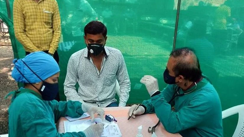 Vijay Nursing Home Dr Atul Vadgaonkar (right) and one of his team members with a patient at Vijay Nursing Home, Nashik