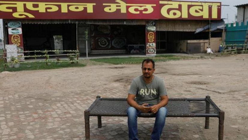 dhaba owner Vikas Malik, owner of a dhaba, a small restaurant, sits for a picture in front of his temporarily closed dhaba along a national highway in Murthal, in Haryana (Photo: Reuters)