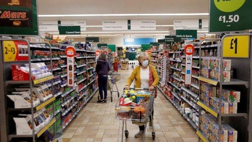 A customer wearing a protective face mask shops at a grocery store (Photo: Reuters) A customer wearing a protective face mask shops at a grocery store (Photo: Reuters)