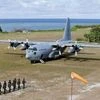 This April 21, 2017, file photo shows a Philippine Air Force C-130 transport plane as Philippine troops march at the Philippine-claimed Thitu Island off the disputed Spratlys chain of islands in the South China Sea in western Philippines. The Philipp