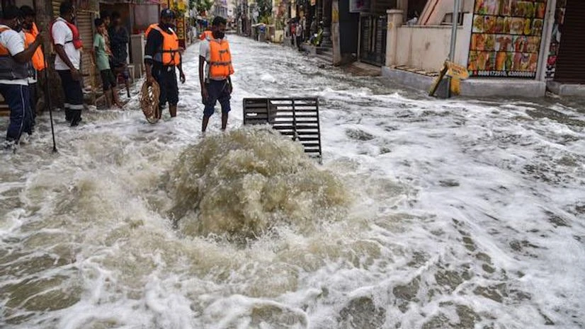 Telangana rains DRF team near the overflowing drain due to heavy rains from past two days, in Hyderabad (Photo: PTI)