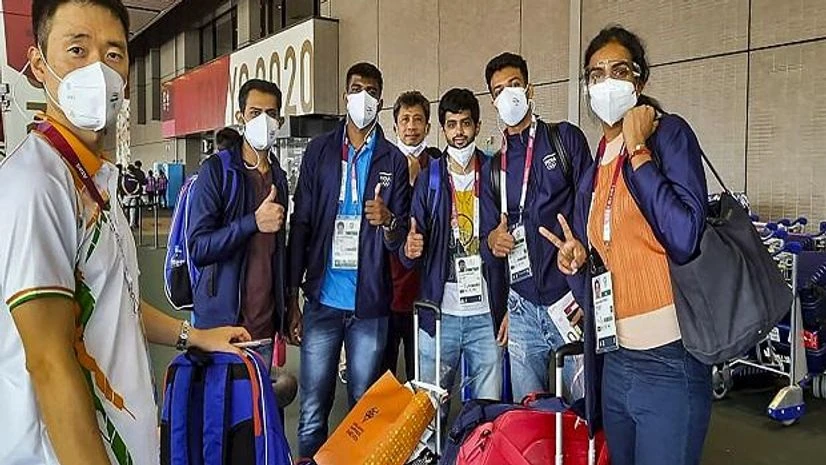 Tokyo Olympics, India Contingent Indian badminton team pose for photographs as they leave for Olympic village, ahead of Tokyo 2020 Olympics, in Tokyo (Photo: PTI)