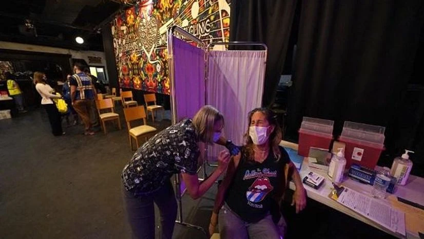 Covid-19 vaccine procurement Allison Richter receives the Moderna COVID-19 vaccine from volunteer RN Maggie Baker, during a vaccine event hosted by Nola Ready, where people received a free drink at the bar if they received a COVID-19 vaccine, at The Howling Wolf (Photo: AP)
