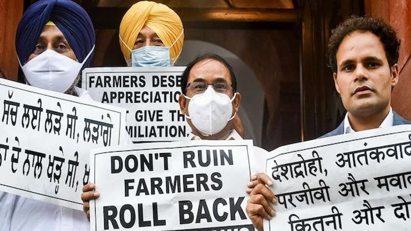 MPs of Opposition parties in Parliament hold placards demanding the repeal of three farm reform laws, staging a protest on July 28, 2021. (PTI Photo/Arun Sharma) MPs of Opposition parties in Parliament hold placards demanding the repeal of three farm reform laws, staging a protest on July 28, 2021. (PTI Photo/Arun Sharma)